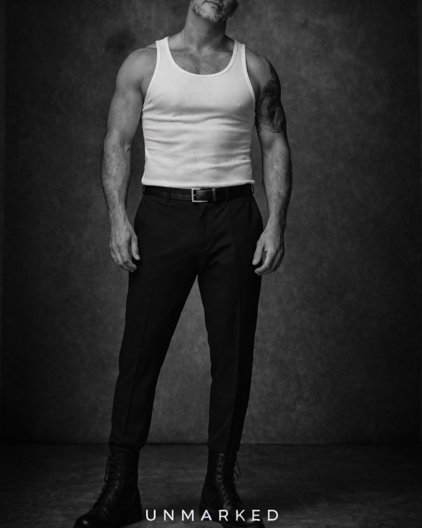 UNMARKED minimal jewellery collection image featuring tailored black trousers and unengraved dog tag necklace styling