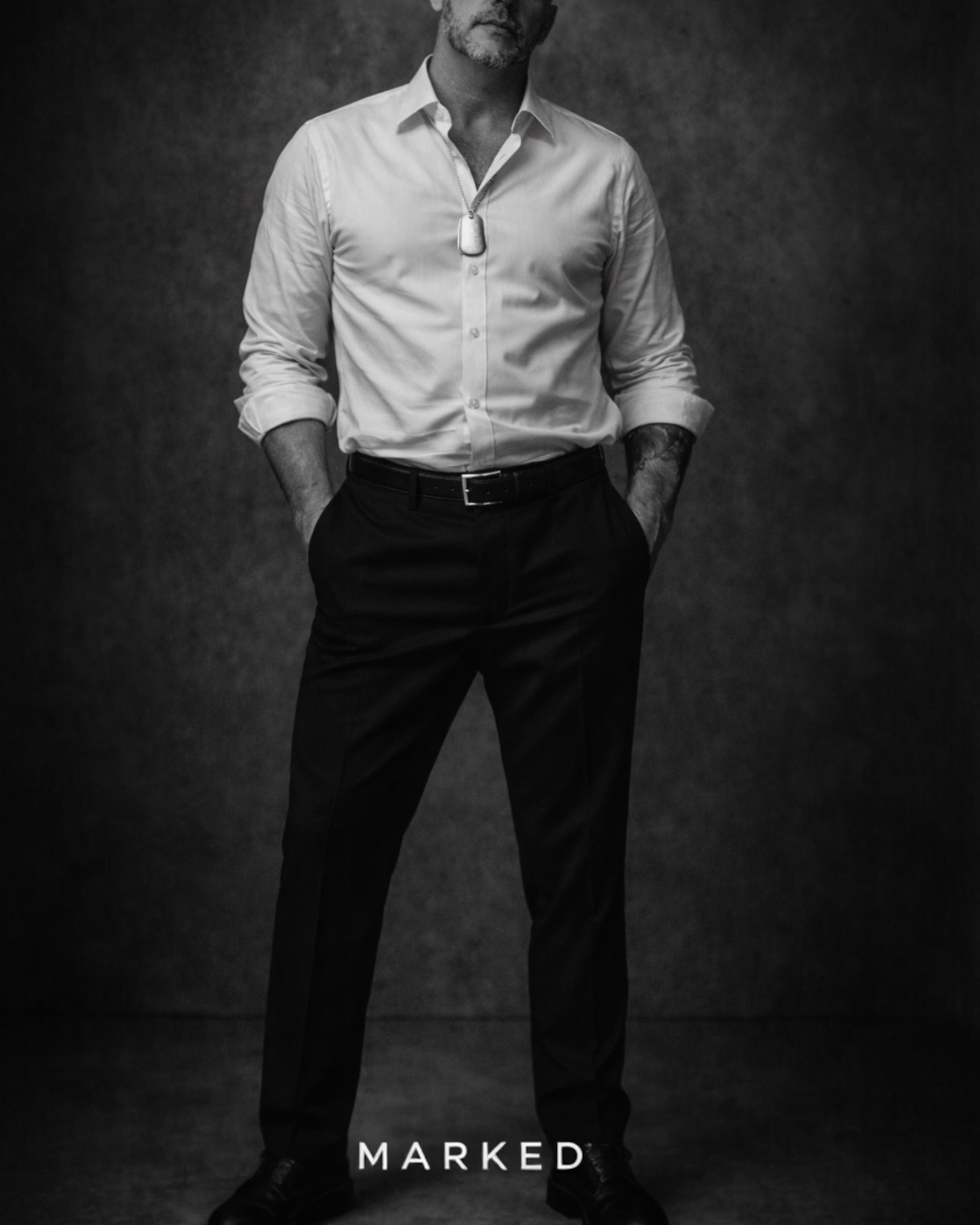 Man in tailored black trousers and white shirt wearing sterling silver dog tag necklace – MARKED DOMINION collection