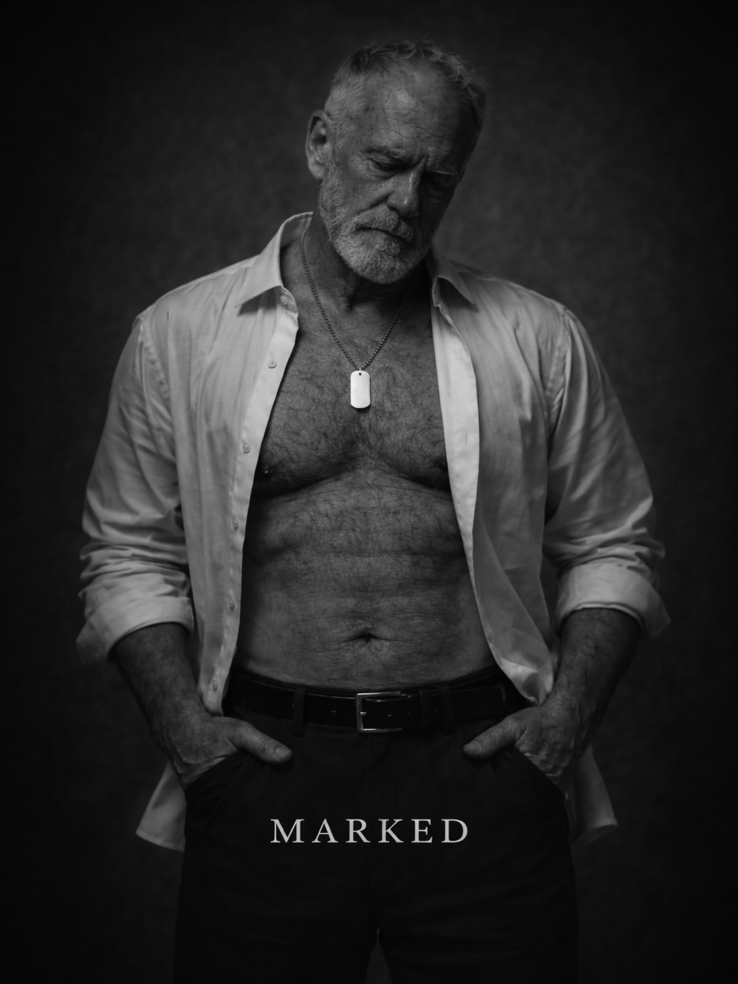 Mature masculine man in open shirt wearing a dog tag necklace, black and white portrait representing experience, authority and strength – MARKED jewellery